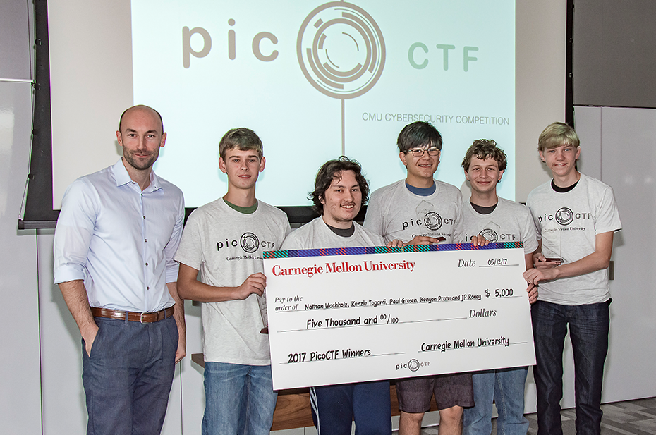 5 student winners and faculty advisor holding prize money from picoCTF