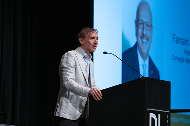 Photo of Alessandro Acquisti speaking at a podium