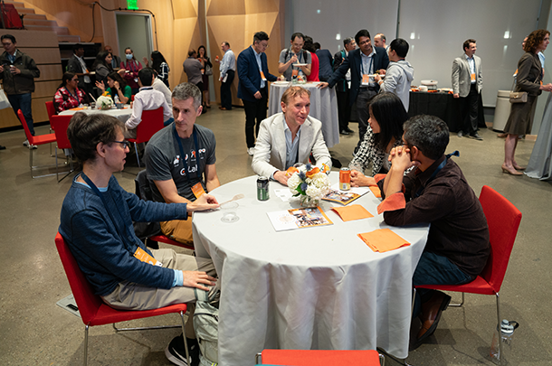 Photo of people eating and socializing at a dinner and reception