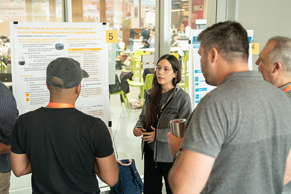 Photo of a student presenting her research poster at the CyLab Partners Conference