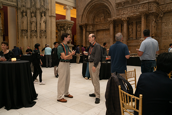 Photo of two people having a conversation at the Carnegie Museum of Art Hall of architecture