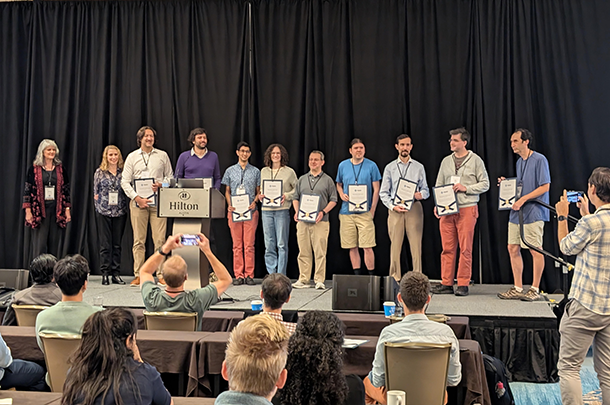 Photo of researchers accepting SOSP Distinguished Artifact Award