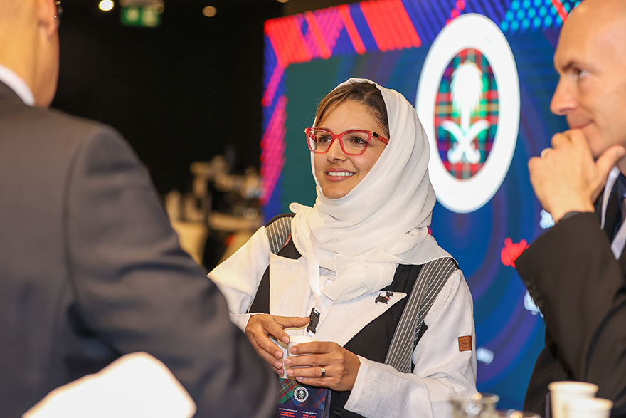 Photo of Hanan Hibshi having a conversation at the 2025 Global Cybersecurity Forum Carnegie Mellon University Alumni event