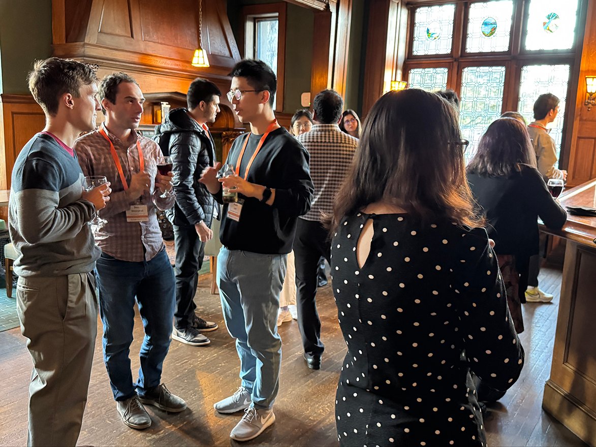 Photo of a group of people talking in the Oak Room at Mansions on Fifth
