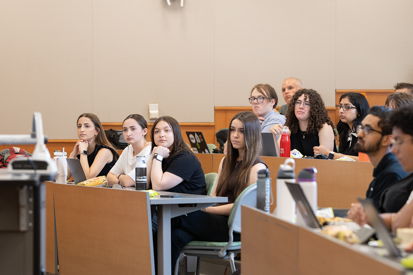 photo of undergraduate college students sitting in a classroom attending a presentation